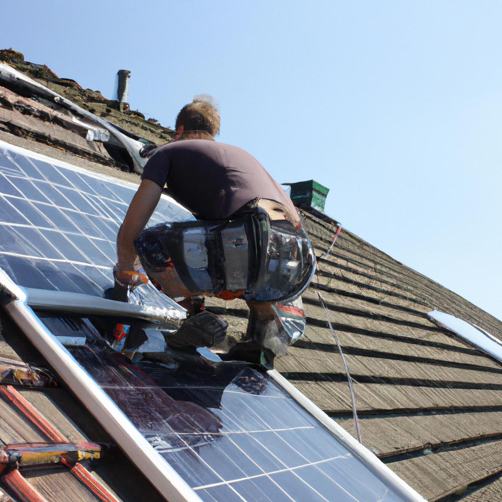 Person installing solar panels on roof